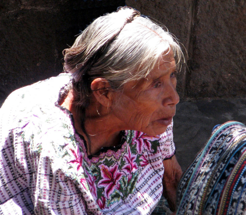 23 Elderly wwoman selling textiles in Solala